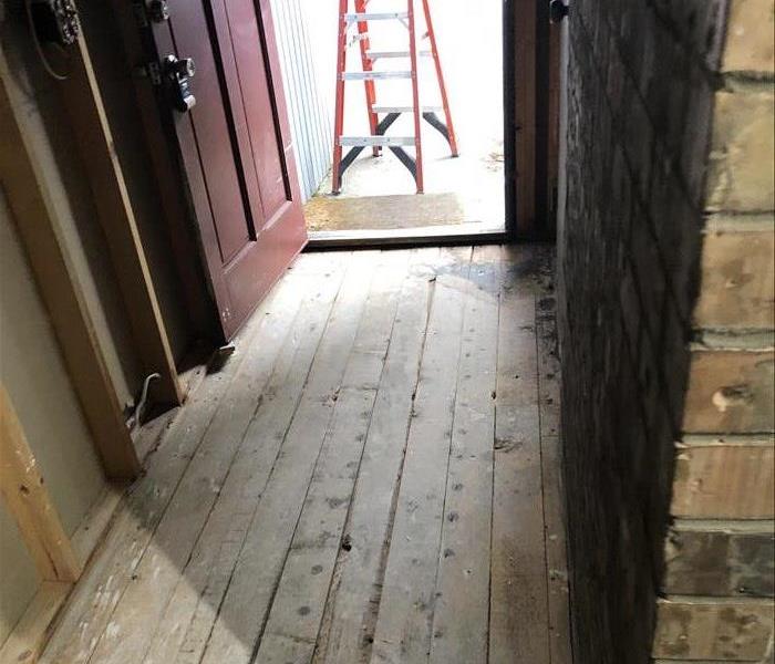 Hallway showing drywall and flooring removed
